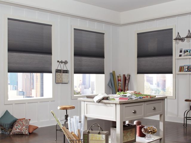 Top-down bottom-up cellular shades lowered from the top in a home office