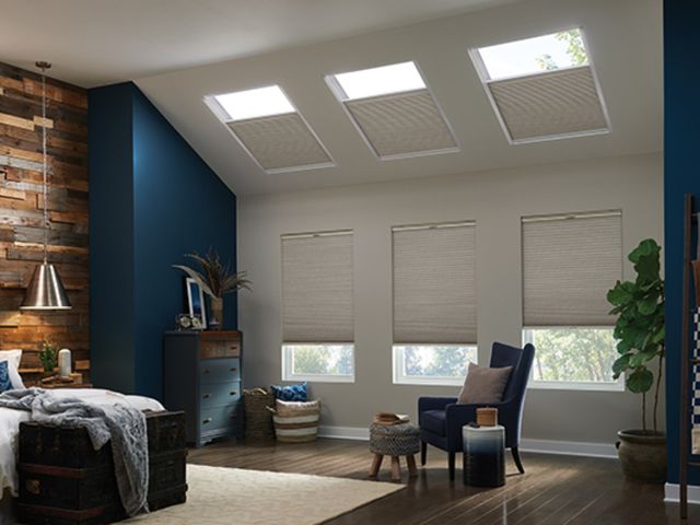 Cellular shades in a bedroom with skylights